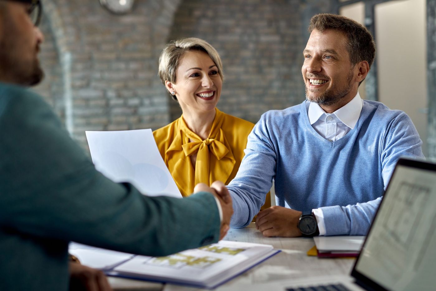 Couple discussing a mortgage pre-approval with an agent